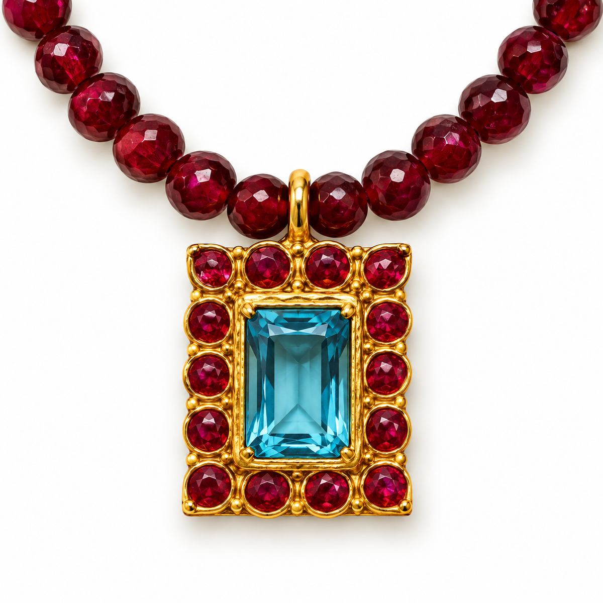 Aquamarine centre stone with red gemstone detailing in a 24K gold-plated pendant by Bote A Mano