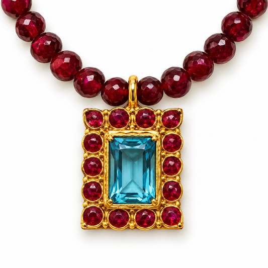 Aquamarine centre stone with red gemstone detailing in a 24K gold-plated pendant by Bote A Mano