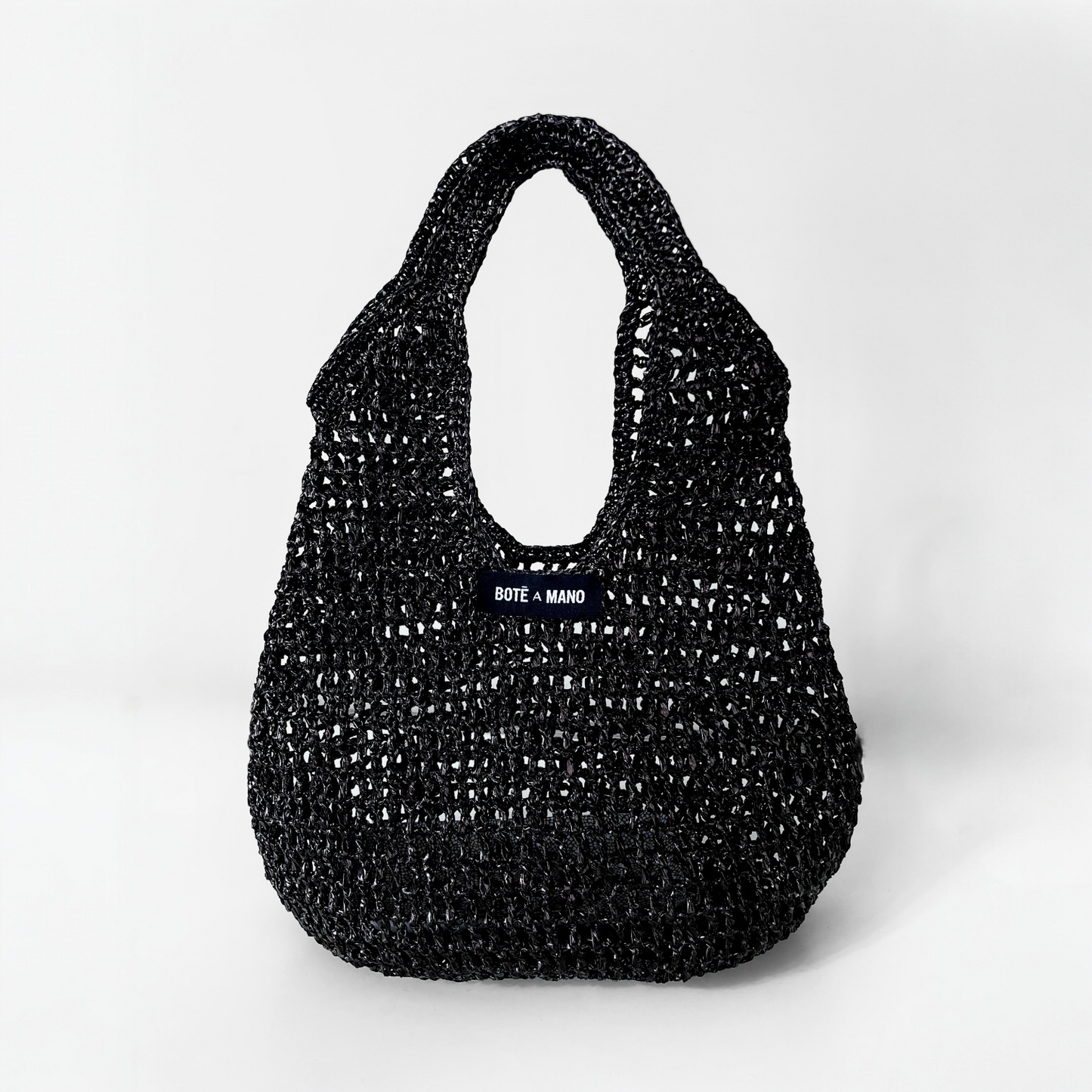 Bote A Mano Black Raffia Top Handle Bag handcrafted by female artisans, featuring a structured silhouette and woven texture