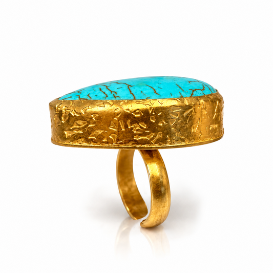 Side view of Bote A Mano Paisley Turquoise Statement Ring with textured 24K gold-plated setting