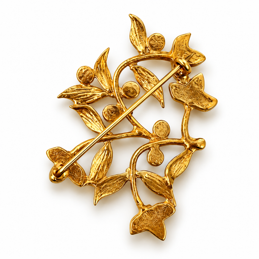 Back view of Bote A Mano gold floral brooch with deep blue stones and pin fastening