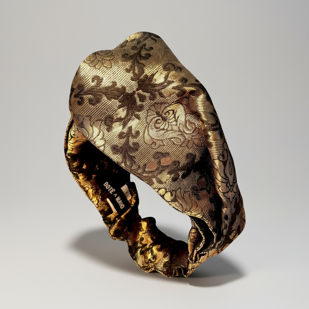 Close-up of BOTE A MANO black and gold brocade fabric twist headband, perfect for formal party outfits.