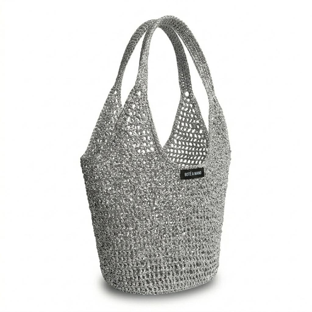 Side view of silver raffia bag showing flexible structure and metallic woven finish by Bote A Mano.