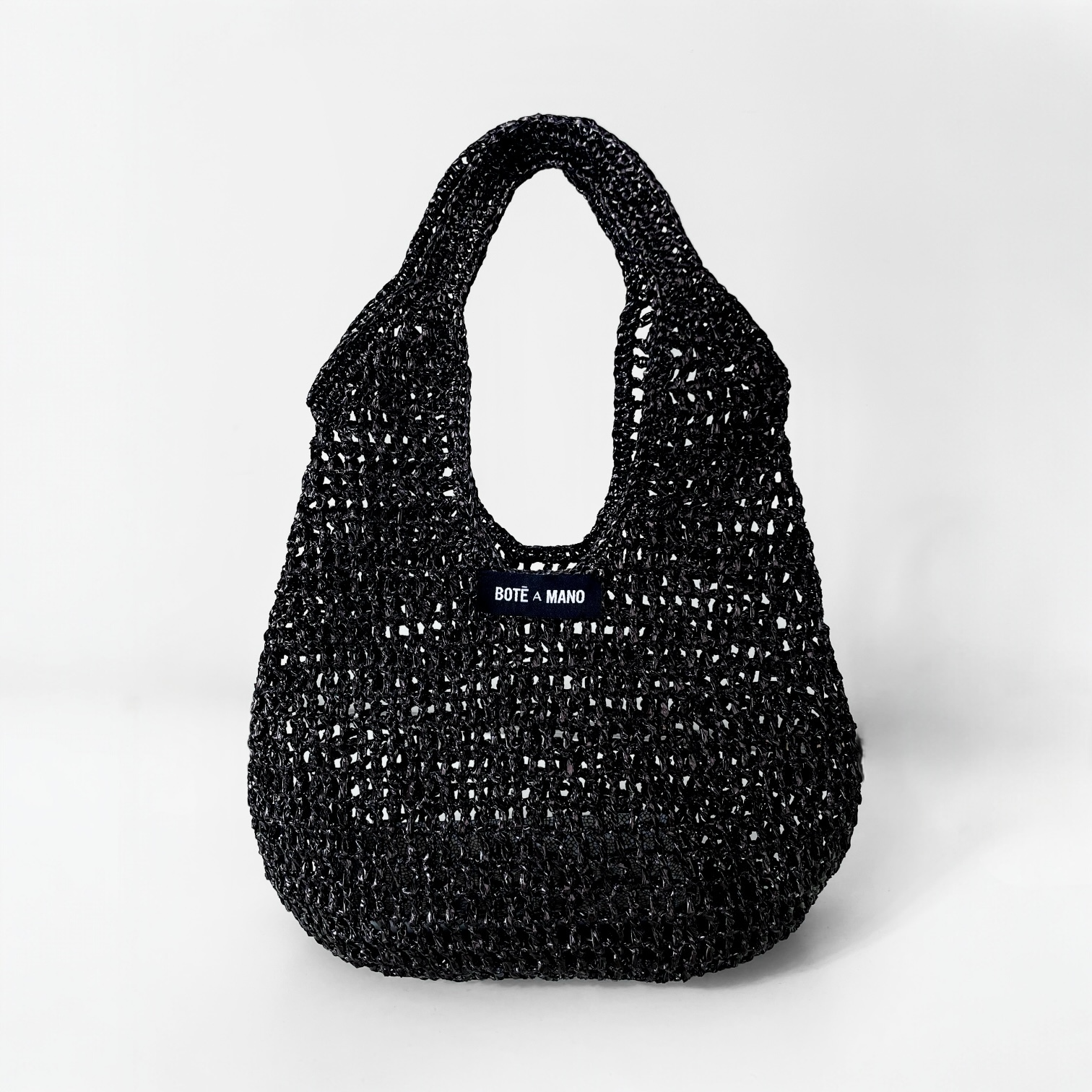 Bote A Mano Black Raffia Top Handle Bag handcrafted by female artisans, featuring a structured silhouette and woven texture
