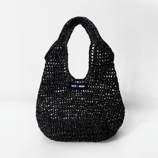 Bote A Mano Black Raffia Top Handle Bag handcrafted by female artisans, featuring a structured silhouette and woven texture