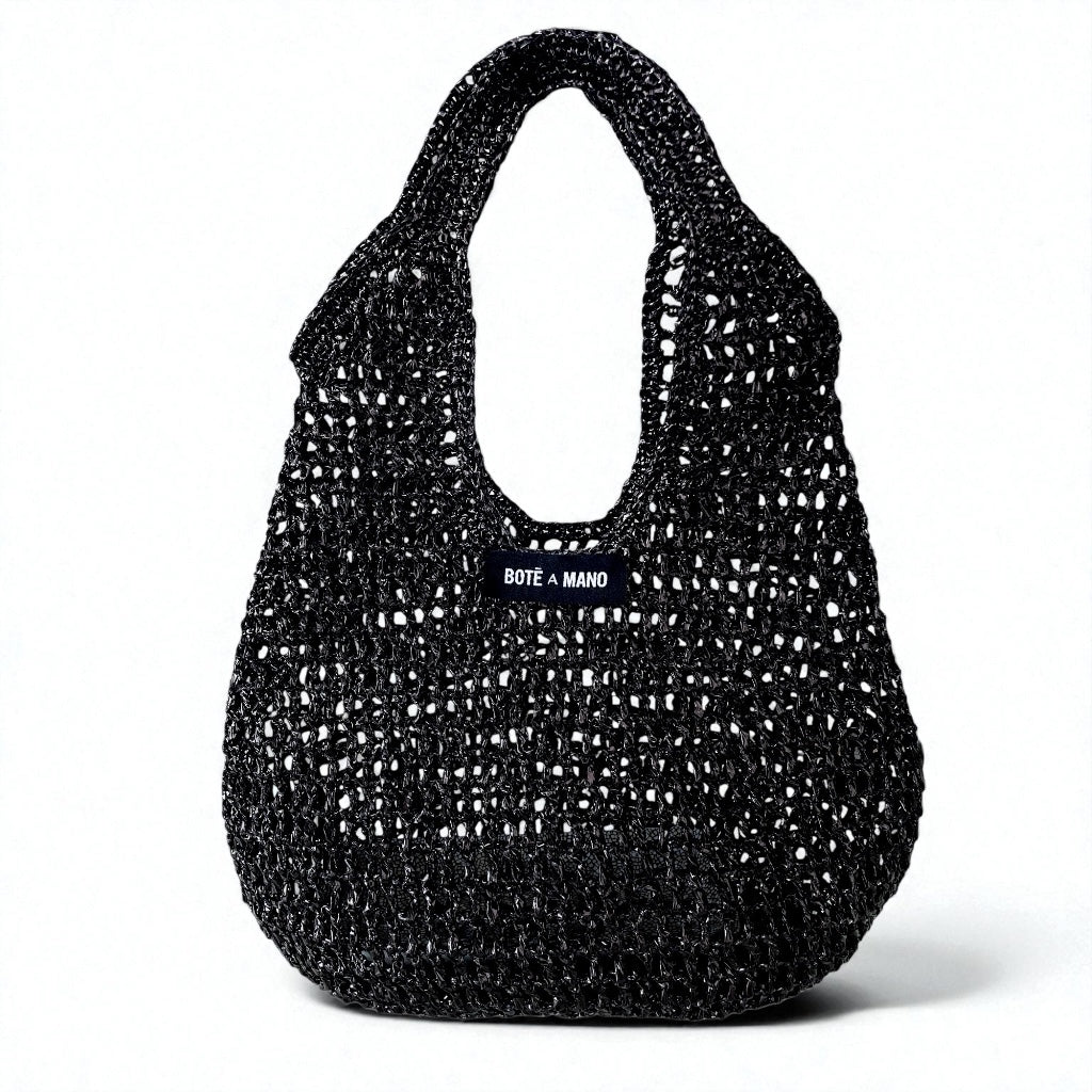 Bote A Mano Black Raffia Top Handle Bag handcrafted by female artisans, featuring a structured silhouette and woven texture