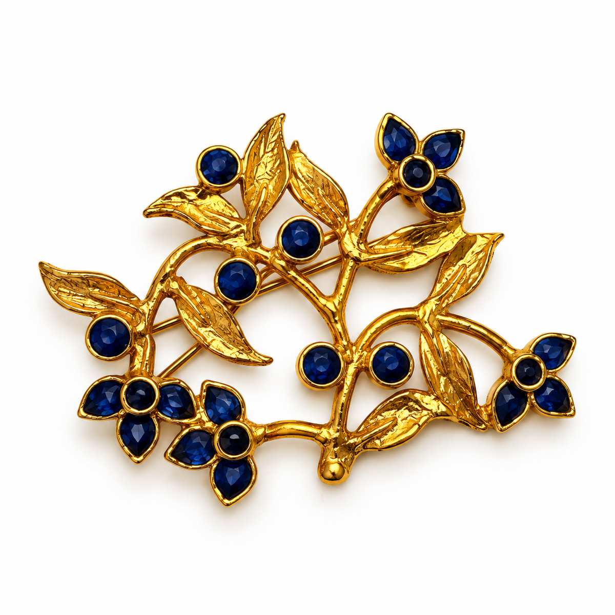 24K gold-plated floral brooch with deep blue stones and sculptural leaves by Bote A Mano