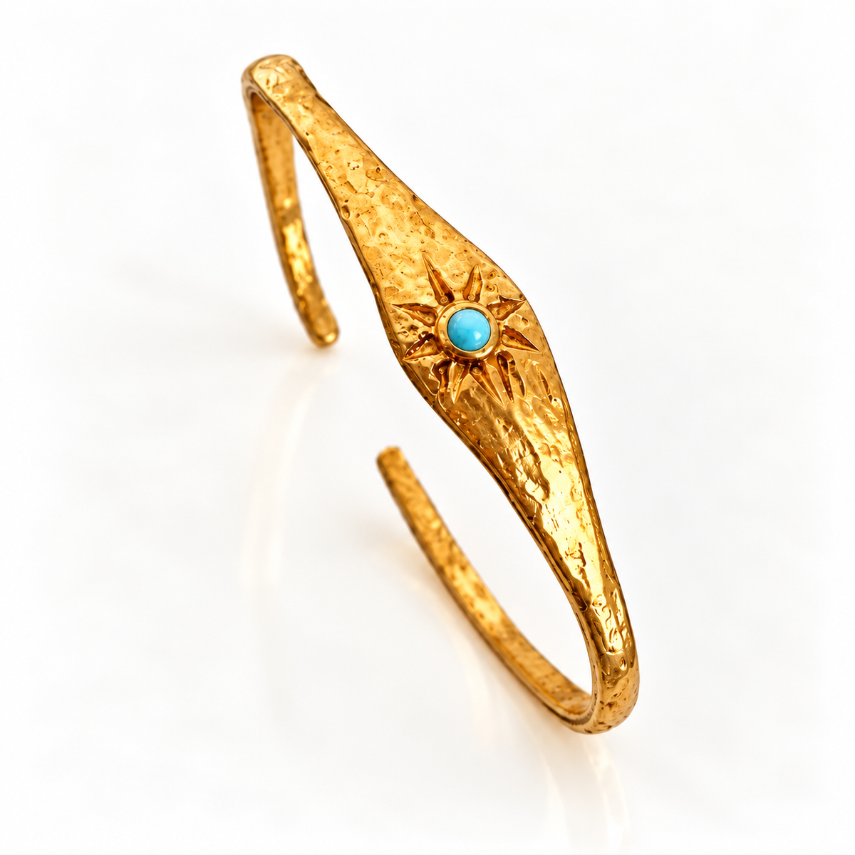 Close-up of turquoise stone and sunburst motif on Bote A Mano 24K gold-plated bracelet