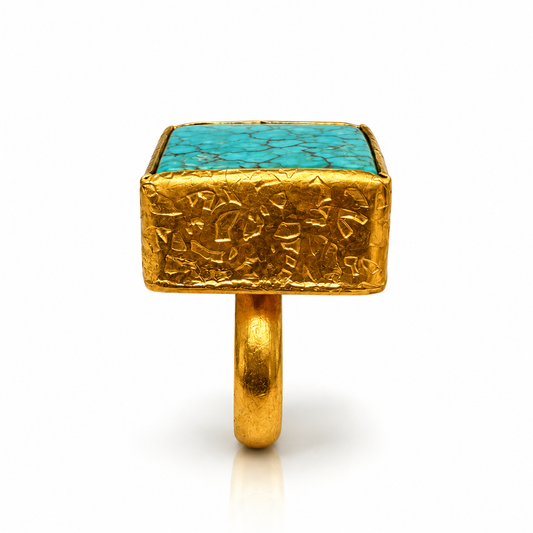 Side view of Bote A Mano square Turquoise ring with textured 24K gold-plated setting