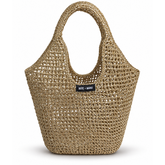 Gold raffia handbag with Bote  a Mano label on a white background