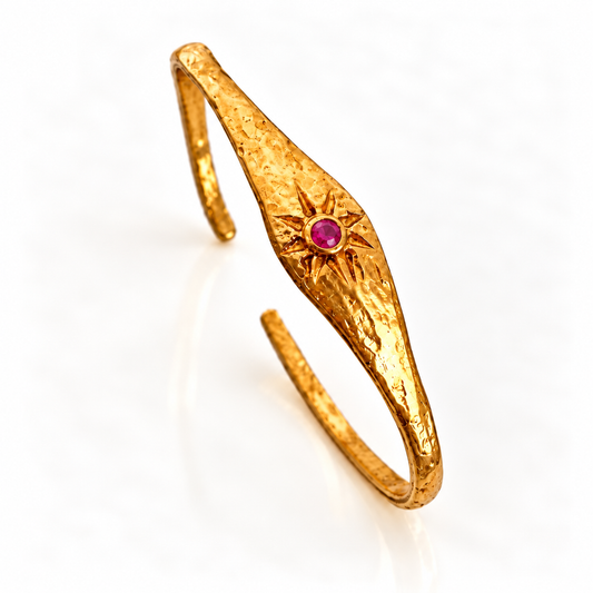 Close-up of Pink Tourmaline stone set in a 24K gold-plated sunburst bracelet by Bote A Mano