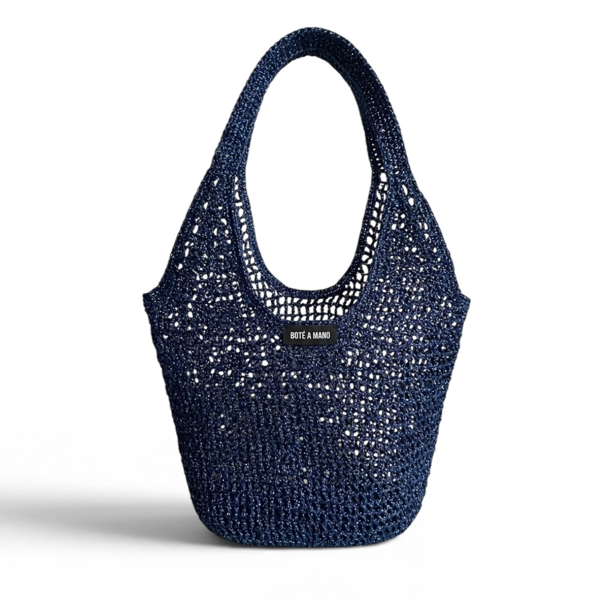 Dark blue metallic raffia bag by Bote A Mano, handcrafted with a soft structure and shimmering woven texture.