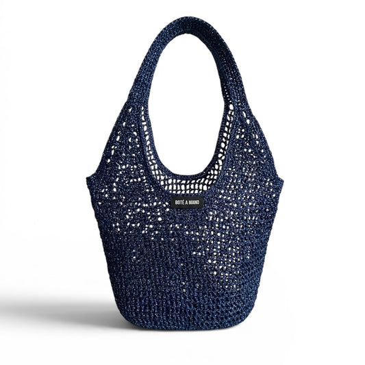 Dark blue metallic raffia bag by Bote A Mano, handcrafted with a soft structure and shimmering woven texture.