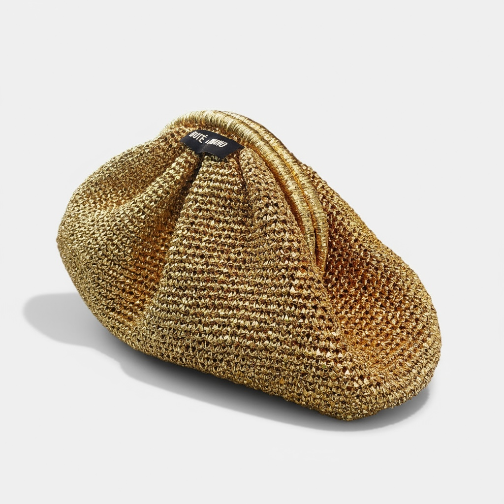 Top view of the handmade Italian gold clutch on a festive table setting, emphasizing its use for a Christmas or formal dinner event.