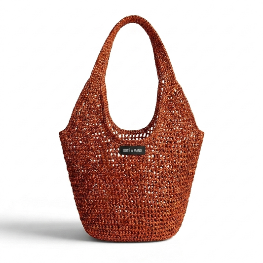 Orange copper metallic raffia bag by Bote A Mano, handcrafted with a sculptural silhouette and shimmering woven texture