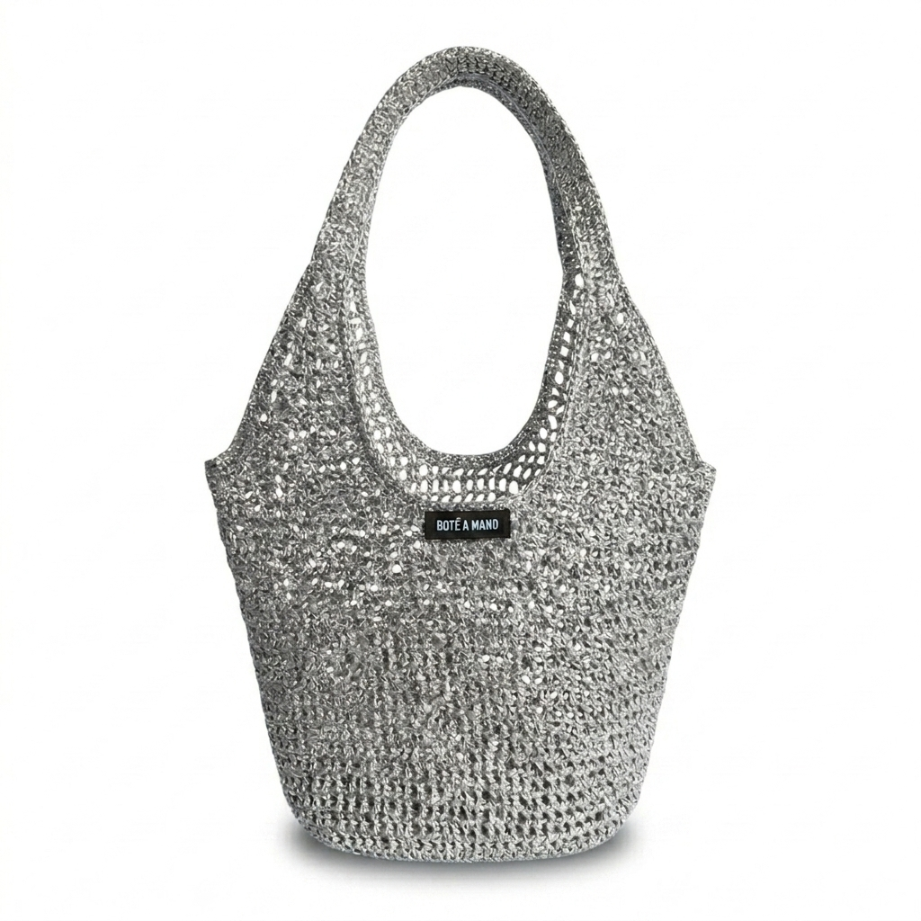 Silver metallic raffia bag by Bote A Mano, handcrafted with a soft structure and shimmering woven texture.