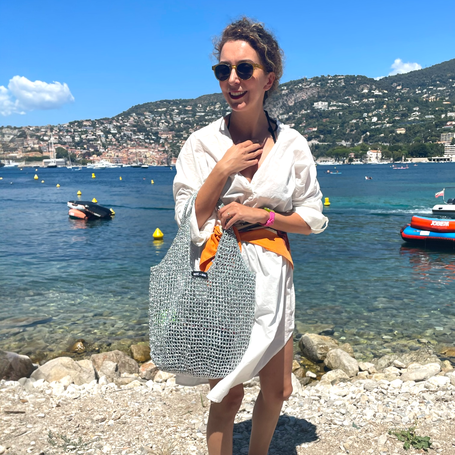 Model carrying silver metallic raffia bag by Bote A Mano in an elegant lifestyle setting