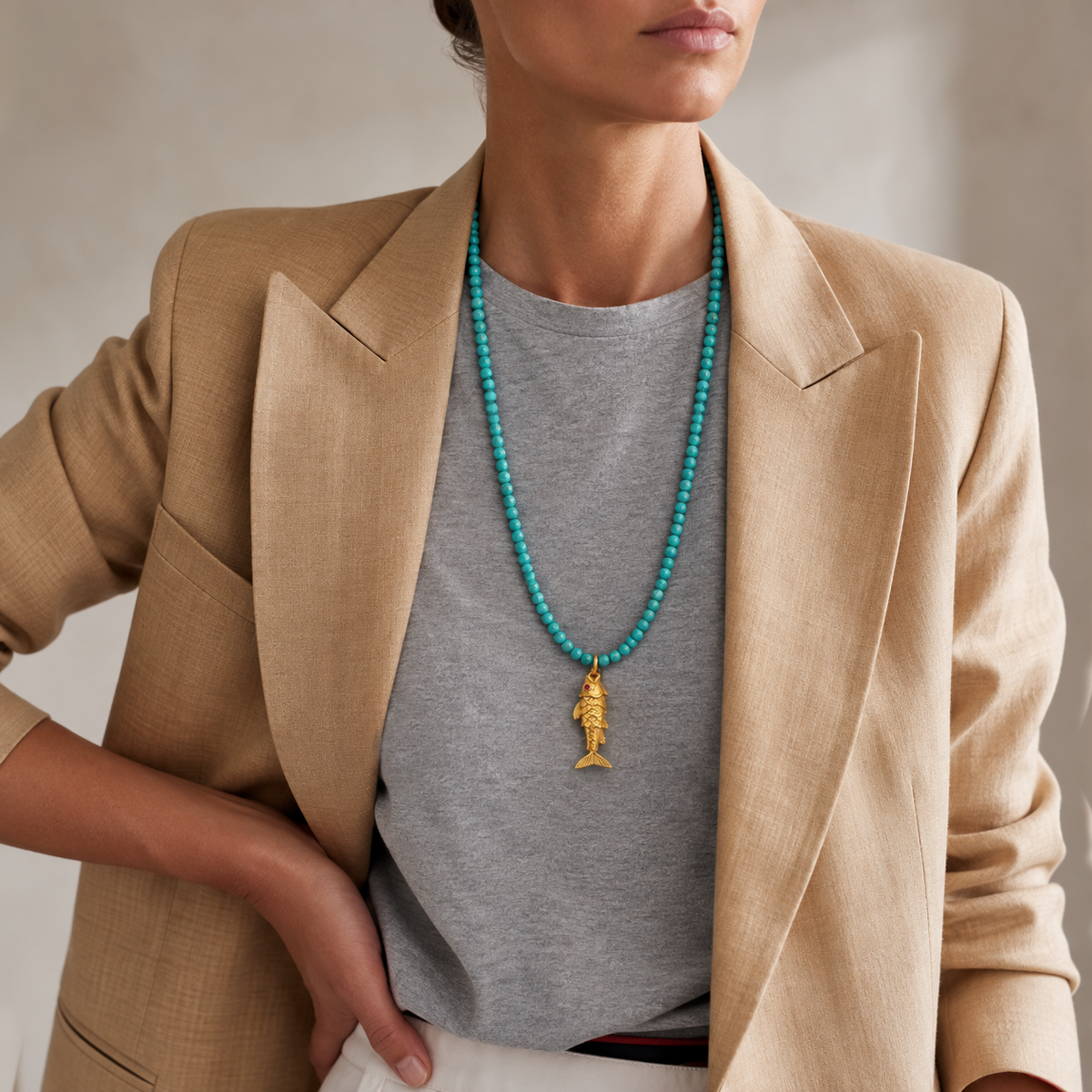 Turquoise bead necklace worn, highlighting natural gemstone color and elegant gold pendant design